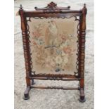 A 19th Century rosewood fire screen with petit point panel of an eagle and spray of flowers, 32"