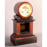 A Tiffany & Co Victorian mantel clock in black slate case with rouge marble insets and visible