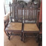 A pair of Victorian Carolean design oak cane seat dining chairs with vine carved central splats