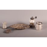 A pierced silver bonbon dish, a silver and glass pepper grinder, two glass and silver match strikers