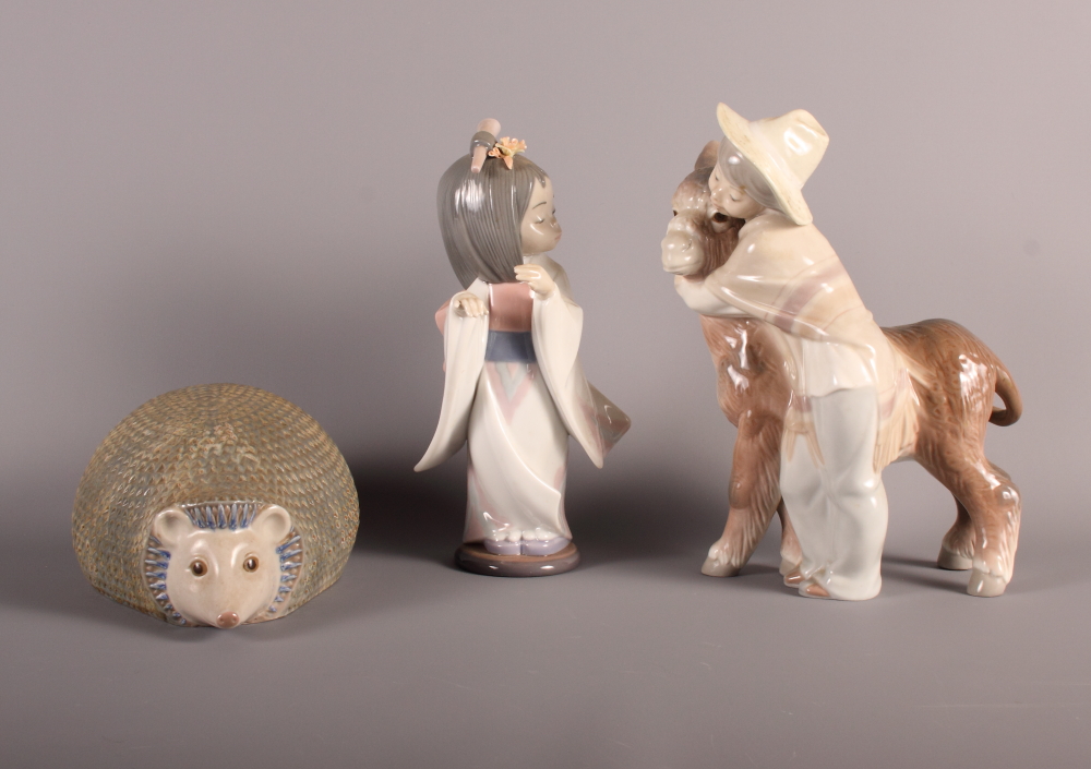 A Lladro figure of a child with donkey, a Lladro figure of Japanese girl and a Lladro model of a