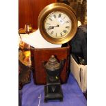 A circular brassed wall clock on white base, a Victorian black slate side vase and a tooled