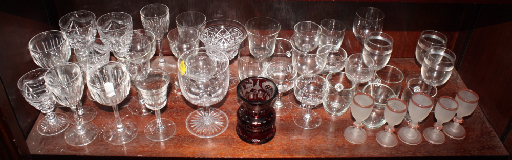 A 19th Century ruby flashed glass urn shaped vase and a collection of assorted drinking glasses
