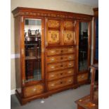 A late 19th Century mahogany and ash three-section wardrobe, the centre section fitted drawers and