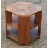 A figured walnut octagonal book table, fitted two undershelves