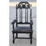 A Victorian 17th Century design oak armchair with scroll pierced cresting, wavy splats, nailed