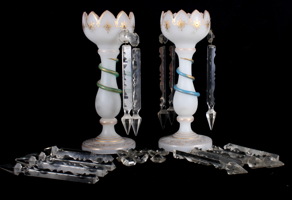 A pair of Victorian white glass table lustres with spear point drops, stems decorated entwined