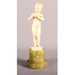 An Art Deco ivory figure, boy with apple, signed F Preiss, on onyx plinth, 6 3/4" high