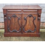 A 19th Century mahogany side cabinet, fitted two frieze drawers over cupboard enclosed two scroll