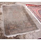 A Persian design silky pile rug decorated central pink anchor medallion on a turquoise ground