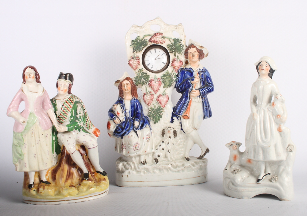 A 19th Century Staffordshire watch holder group, another Staffordshire group, Highland couple, and a