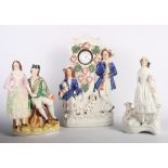 A 19th Century Staffordshire watch holder group, another Staffordshire group, Highland couple, and a