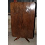 A Georgian mahogany tilt top breakfast table, on turned column and quadruple splay supports with