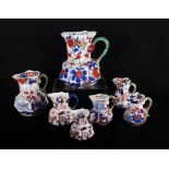 Seven 19th Century ironstone snake handled jugs, Mason's, Davenport, etc, largest 8" high