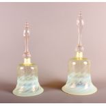 A Victorian Vaseline glass bell with spiral decoration, 13" high, and a smaller similar, 11 1/2"
