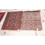 A Bokhara prayer rug decorated thirteen octagonal guls on a reddish brown ground and a similar rug