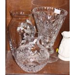 A cut glass trumpet vase, 11" high, a bulbous cut and engraved vase and one other vase with grape
