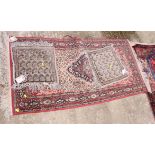 A Persian design rug decorated central medallion on red and beige ground and a pair of square mats