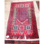 A Caucasian wool prayer rug decorated central mihrab and five vertical trails on a red and blue