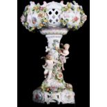 A 19th Century Sitzendorf style floral encrusted tablecentre, central stem decorated two cherubs,