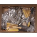 An assortment of loose silver plated cutlery and bone handled cutlery