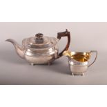 A Georgian silver melon-shaped teapot with engraved decoration and a matched silver milk jug, 27oz