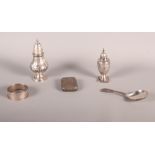 Two silver pepperpots, a silver napkin ring, a silver caddy spoon and a silver vesta case, 4.7oz