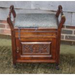 An early 20th Century polished as mahogany box seat piano stool with turned side rails and