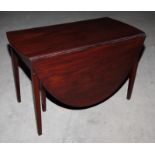 A Georgian mahogany oval drop leaf dining table, on square taper supports, 44" wide