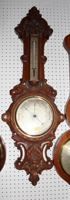 A Victorian aneroid barometer in carved oak case by J H Steward 457 West Strand