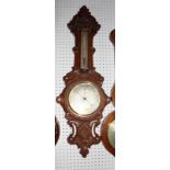A Victorian aneroid barometer in carved oak case by J H Steward 457 West Strand