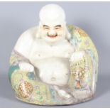 A Chinese porcelain polychrome decorated seated Buddha, 9 1/2" high