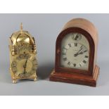 A Gamages mantel clock in arch top mahogany case and a 17th Century design brass lantern clock