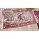 A Persian design rug decorated central medallion on red and beige ground and a pair of square mats