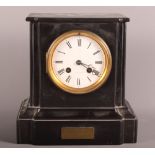 A 19th Century mantel clock in black slate case with presentation plaque dated 1875, 9" high