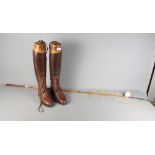 A coachman's 19th Century whip and riding boots in brown leather