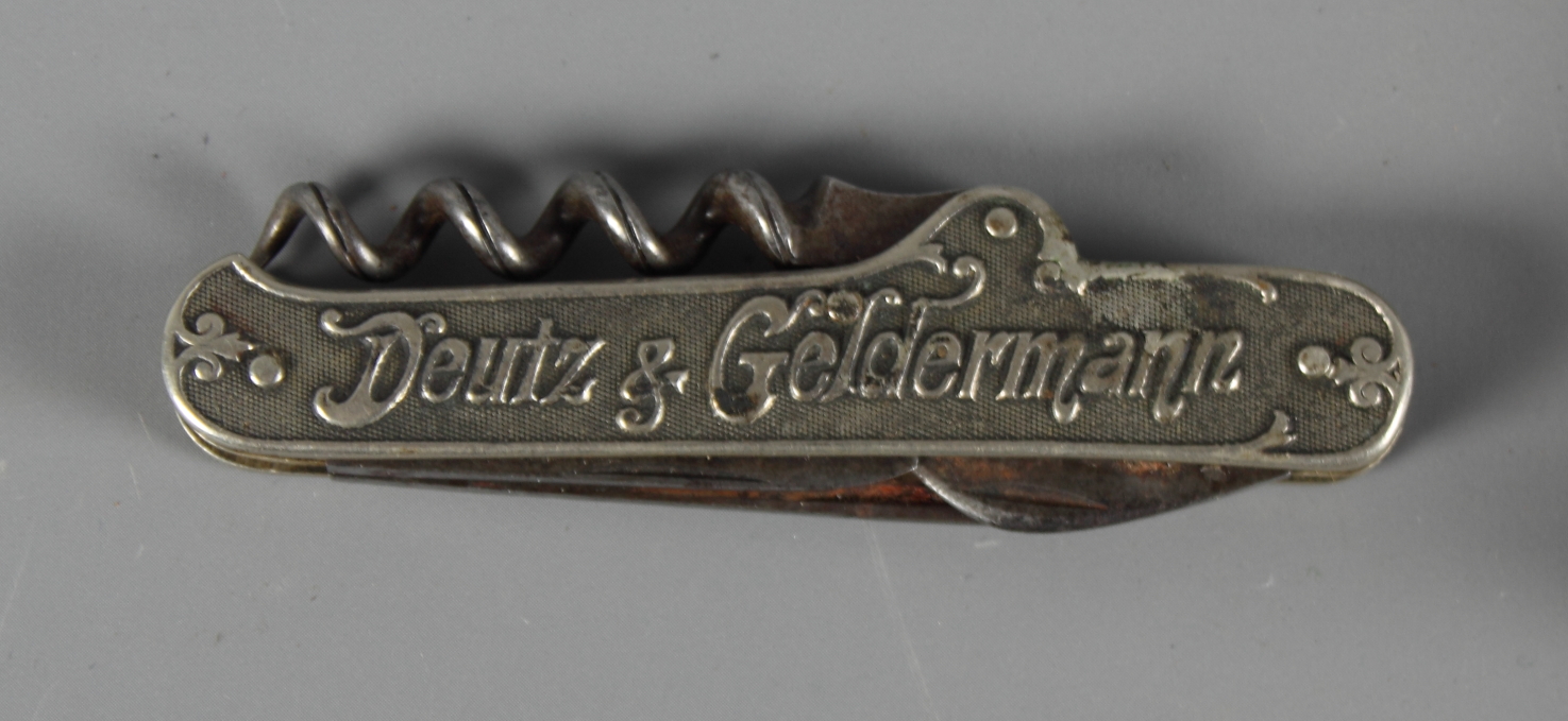 A brass corkscrew with turned wooden handle and a folding corkscrew advertising Goldtrack champagne - Image 2 of 2