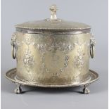 A late 19th Century silver plated oval biscuit box with embossed and engraved decoration