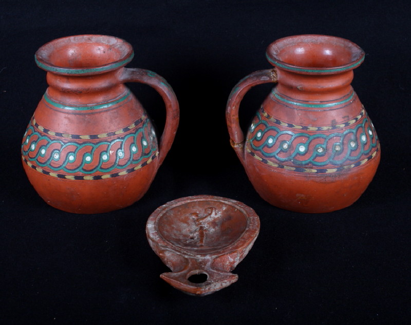 A Roman Samian ware pottery oil lamp moulded figure and a pair of early Pratt ware terracotta