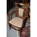 An Edwardian inlaid rosewood framed armchair with back and seat covered floral tapestry