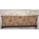 A 19th Century ottoman, upholstered in a floral print fabric, 48" long (for reupholstery)