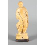 A 19th Century Dieppe ivory carving of a saint (a/f) on wooden base, 4 1/4" high