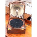 A portable gramophone by the Gramophone Company, leather covered case with lid inset hemispherical