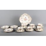 A Dresden floral decorated part teaset comprising six cups, saucers, side plates and a comport