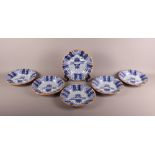 A set of six 19th Century Delft wall plates with floral decoration, 9" dia