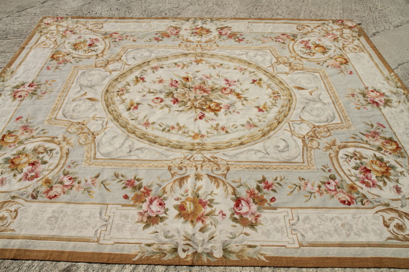 An Aubusson type tapestry carpet of traditional 18th Century design, roses on a light ground, 93"