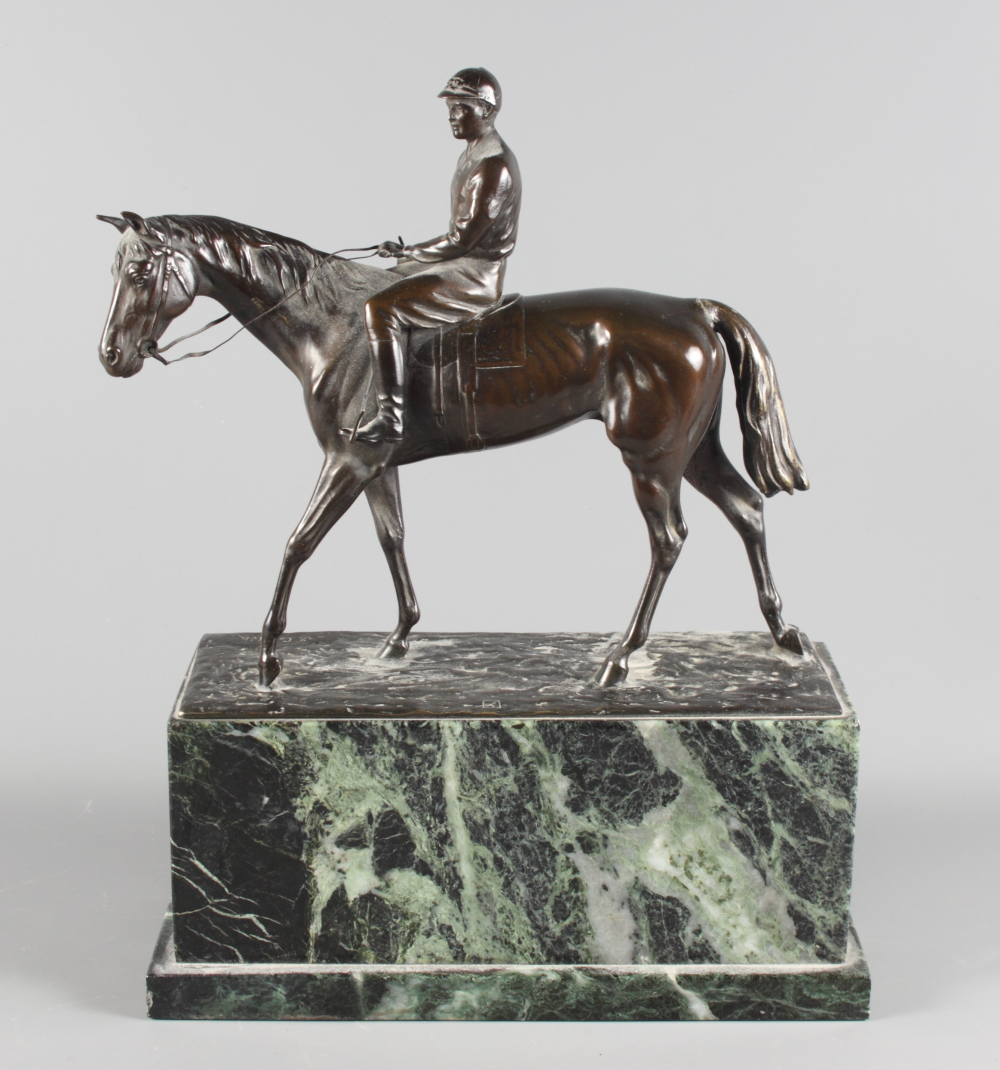 J Csadek: a bronze model of a racehorse with jockey up, on green marble plinth, 12" long