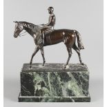 J Csadek: a bronze model of a racehorse with jockey up, on green marble plinth, 12" long