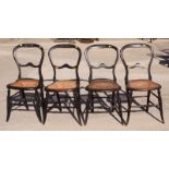 A set of four ebonised cane seat balloon back single chairs