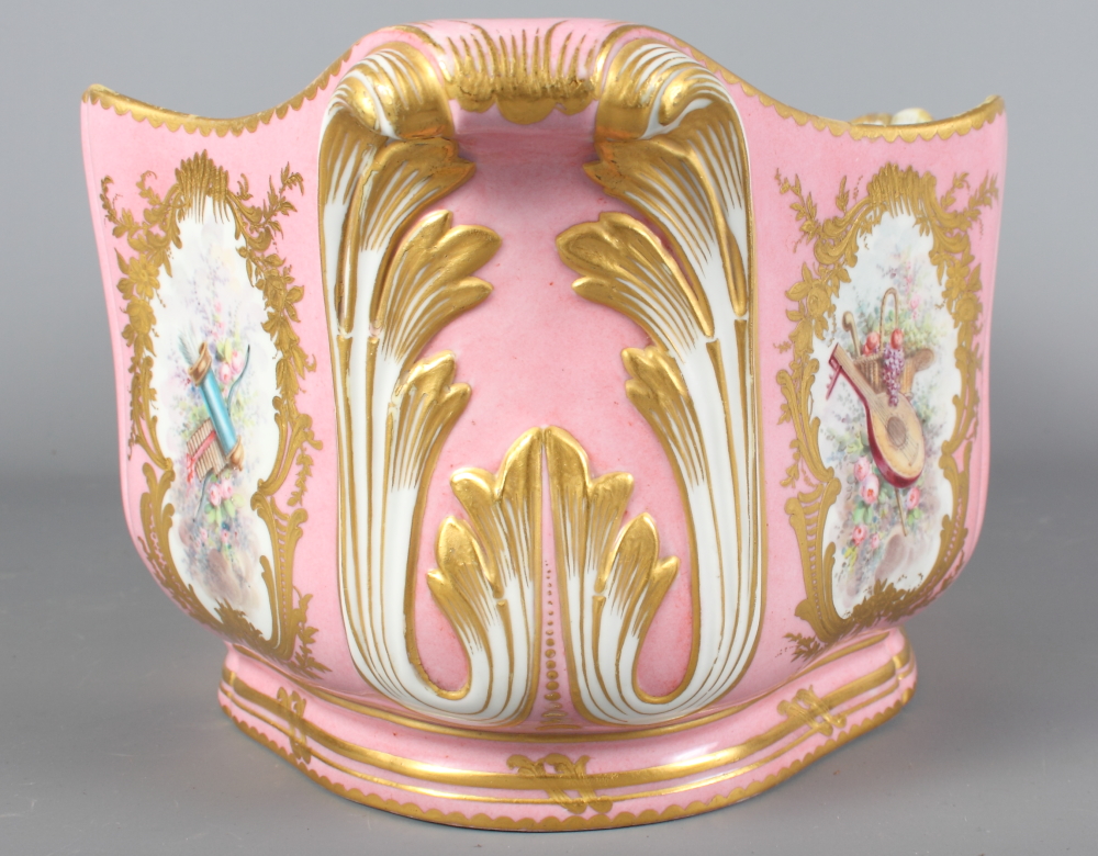 A Sevres porcelain jardiniere decorated reserves of flowers, putti and musical instruments on a pink - Image 4 of 8